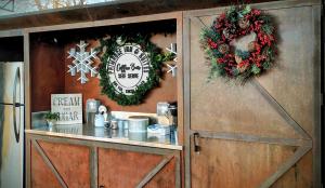 a wooden cabinet with christmas wreaths on it at Primrose Inn and Suites in Chino Valley +7 photos