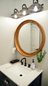 a bathroom sink with a wooden mirror above it at A Cabin in the City with a 5 Star Lush Backyard in Atlanta +91 photos