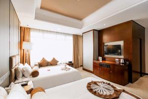 Ένα ή περισσότερα κρεβάτια σε δωμάτιο στο Anji Baihui Hotel
