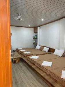 a room with three beds in a room at Lalagigi Homestay in La Gi