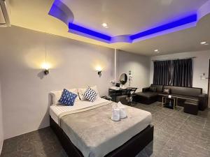 a bedroom with a bed and a living room with a couch at Viphuanan Resort in Nong Prue