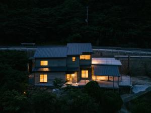 a house with its lights on at night at SEN RETREAT TAKIJIRI - Kumano Kodo Gateway in Tanabe