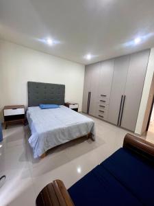 a bedroom with a bed and cabinets in it at Hermosa residencia en San Pedro Cholula in Cholula