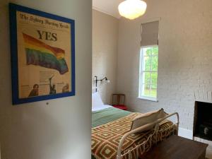 a bedroom with a bed and a poster on the wall at The Ol' Sunday School in Ross