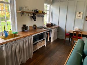 a kitchen with a sink and a counter top at The Ol' Sunday School in Ross +17 photos