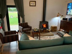 a living room with a couch and a fireplace at The Ol' Sunday School in Ross