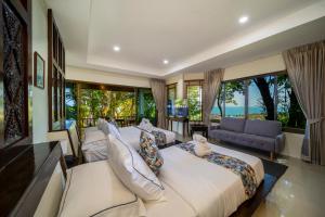 a bedroom with two beds and a large window at Chaweng Bay View Resort by Smith & Appy in Ko Samui