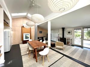 a kitchen and dining room with a table and chairs at Wombat Pavilion in Yanakie