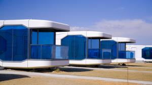 a row of blue and white buildings in a parking lot at Tegri Gobi Resort 