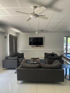 a living room with a couch and a flat screen tv at 80 Tarcutta St in Wagga Wagga