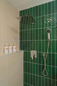 a green tiled bathroom with a shower with an umbrella at Baansiwalin in Phra Nakhon Si Ayutthaya +100 photos