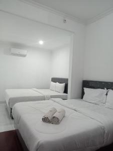 Giường trong phòng chung tại Pakemsari Resort Hotel