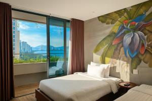 a hotel room with two beds and a mural at MissBamboo Hotel Nha Trang in Nha Trang