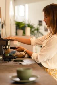 a woman is preparing food in a kitchen at Slow Life Boutique Hotel - Adults Only in Mirissa
