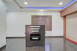 a room with a door and a payment machine at Super Townhouse Vanagaram Apollo Hospital Chennai Formerly V Hotels & Restaurant in Chennai