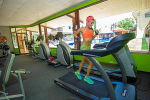 a woman standing on a treadmill in a gym at Gran Hotel Azuero in Chitré