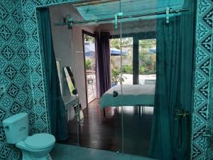 a bathroom with a toilet and a view of a bedroom at Thao’s Villa in Ho Chi Minh City +50 photos