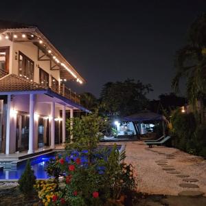 a villa with a swimming pool at night at Thao’s Villa in Ho Chi Minh City