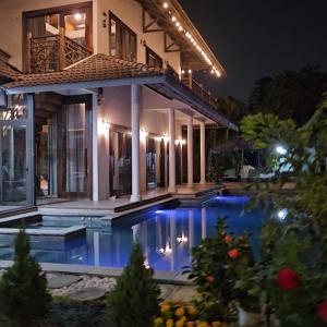 a house with a swimming pool at night at Thao’s Villa in Ho Chi Minh City