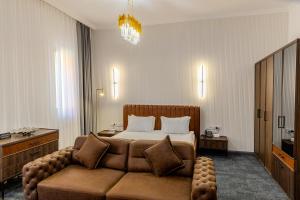a hotel room with a bed and a couch at Infinity Plaza Hotel Block 1 in Atyrau +126 photos