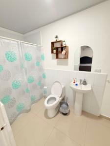 a bathroom with a toilet and a sink at Casa en San Miguel, el salvador in San Miguel +9 photos