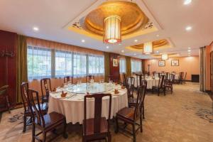 a banquet room with tables and chairs in a building at Shaoxing Yintai Hotel in Shaoxing