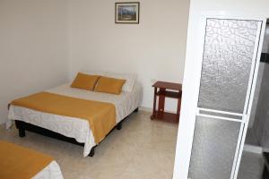 Postel nebo postele na pokoji v ubytování Hotel Abadia