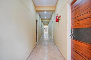 a corridor of a hallway with a door at Hotel O Bidadi Railway Junction Bangalore Formerly Ejalla in Bidadi