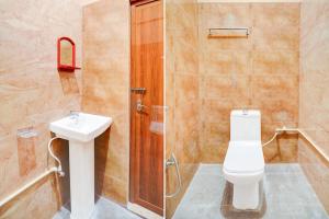 a bathroom with a toilet and a sink and a shower at Hotel O Bidadi Railway Junction Bangalore Formerly Ejalla in Bidadi