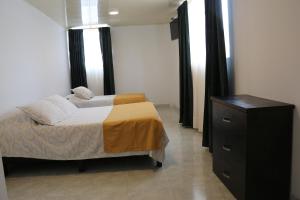 Postel nebo postele na pokoji v ubytování Hotel Abadia