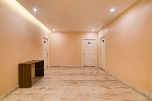 an empty hallway with a desk and two doors at Super Collection O Puri Seaview Formerly Hotel Aavaas in Puri