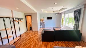 a living room with a couch and a table at Viphuanan Resort in Nong Prue