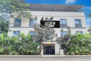 um edifício branco com um sinal preto em Super Hotel O Khadakwasla Lakeview Formerly Gokul Lodge em Kharakvasla