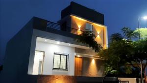 a black and white house with lights on it at Oasis Residency and Resorts in Solapur