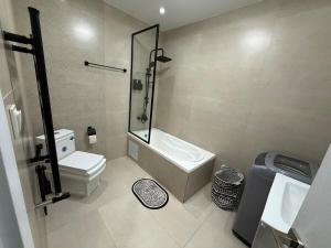 a bathroom with a toilet and a sink and a shower at Panoramic View apartment Seraidi Annaba in Annaba +8 photos