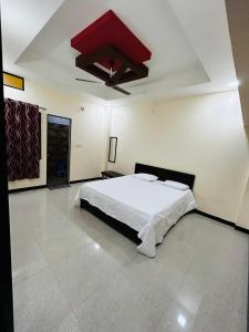 a bedroom with a bed and a red ceiling at Shree Ram Home Stay in Ujjain