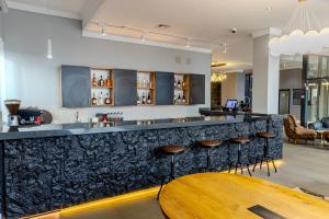 a bar with a wooden table in a room at INFINITY PLAZA BLOCK 1 in Atyraū