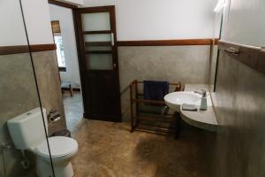 a bathroom with a toilet and a sink at The 6th Milepost Tea Bungalow Bandarawela in Bandarawela