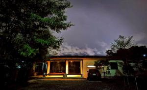 a house with a car parked in front of it at Little Tree Hut Bangkachao in Bang Chak