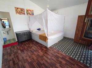 a room with a bed with a tent in it at Mountain Palm patnem beach in Patnem