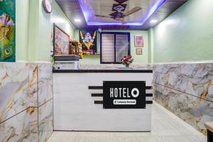 a hotel lobby with a halo sign on a counter at Hotel O Gymkhana Dombivli Mumbai in Dombivli