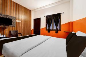 Кровать или кровати в номере Super Hotel O Coimbatore International Airport East Zone