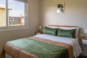a bedroom with a large bed with a window at Femiba in El Calafate +33 photos