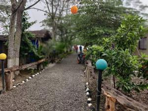 a garden with a pathway with trees and an orange ball at Narayani view resort in Bharatpur
