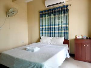 Un dormitorio con una cama con dos toallas encima. en Unique Village, en Boāli