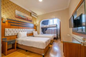 Postel nebo postele na pokoji v ubytování Big Apple Hotel and Hostel