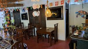a dining room with tables and chairs in a restaurant at Kavidi Villa Home Stay in Tangalle +28 photos