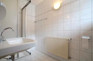 a white bathroom with a sink and a shower at Sonneck Ferienhaus & Gruppenhaus 1450m am Hochzeiger im Pitztal in Jerzens +90 photos