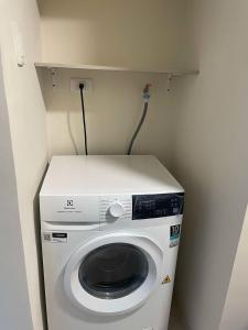 a washer and dryer in a small room at Ocean Garden Villas Cluster B 3rd Floor Unit C in Boracay