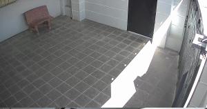 a bathroom with a tile floor and a chair at Battambang Local Homestay in Phumĭ Svay Chh'êh